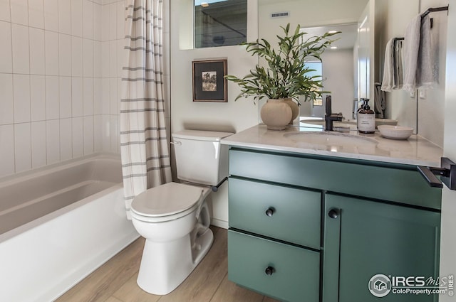 bathroom featuring vanity, wood finished floors, visible vents, toilet, and shower / tub combo with curtain