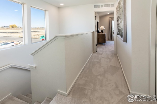 corridor featuring baseboards, visible vents, recessed lighting, light carpet, and an upstairs landing