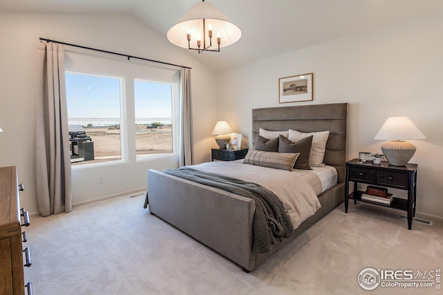 bedroom featuring vaulted ceiling, baseboards, a chandelier, and light carpet