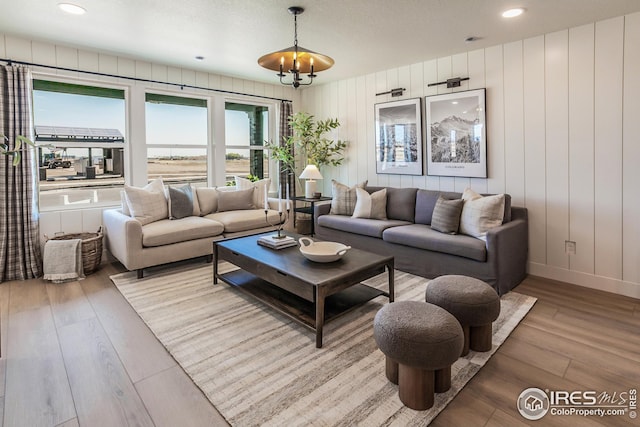 living area with recessed lighting, baseboards, and wood finished floors