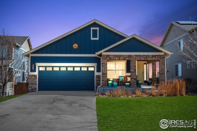 craftsman inspired home featuring a porch, board and batten siding, concrete driveway, an attached garage, and a front yard