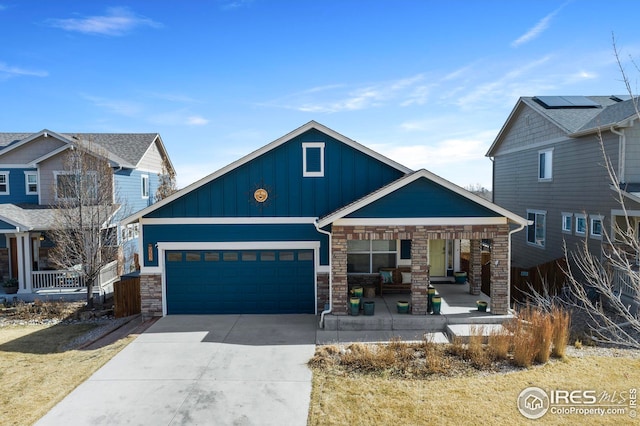 craftsman-style home with a garage, covered porch, board and batten siding, and driveway