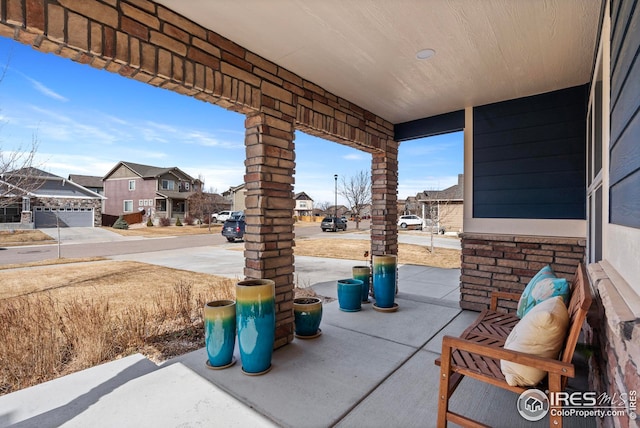 view of patio featuring covered porch and a residential view