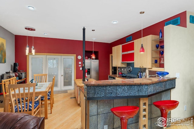 kitchen featuring visible vents, french doors, light wood-style floors, stainless steel refrigerator with ice dispenser, and open shelves