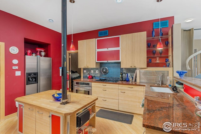 kitchen featuring visible vents, light brown cabinetry, stainless steel appliances, wood counters, and a sink