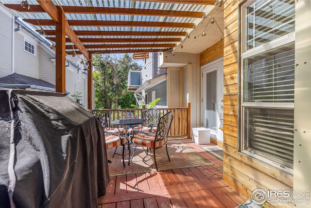 wooden deck featuring area for grilling and outdoor dining space