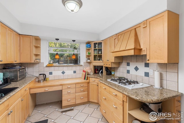 kitchen with open shelves, white gas cooktop, custom exhaust hood, and tasteful backsplash
