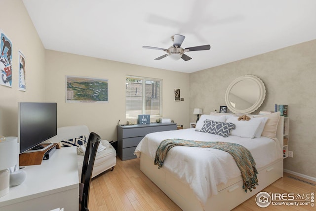 bedroom with light wood-type flooring, baseboards, visible vents, and a ceiling fan