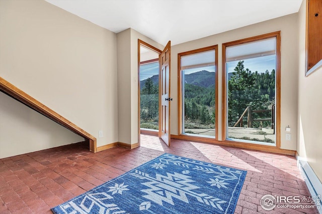 entrance foyer featuring baseboards and brick floor