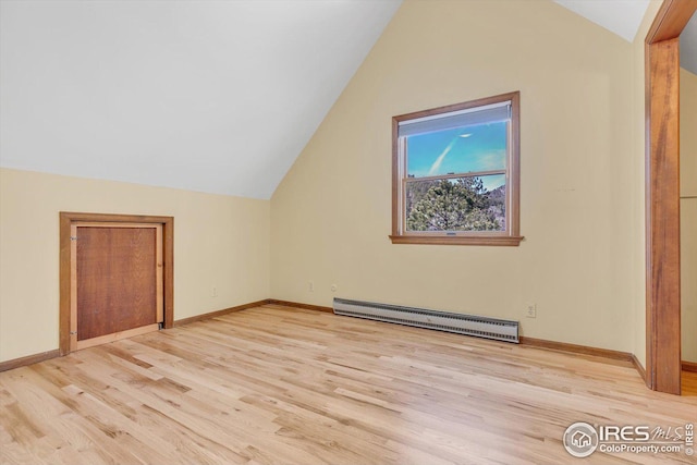 bonus room with a baseboard radiator, lofted ceiling, light wood finished floors, and baseboards