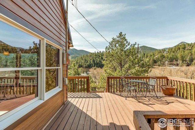 wooden deck with a mountain view