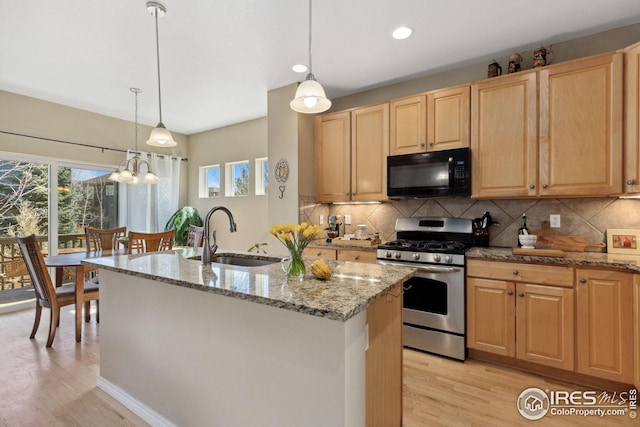 107 Bohn Ct, Lyons, CO 80540 - kitchen with black microwave, stainless steel gas range, a sink, light brown cabinets, and recessed lighting