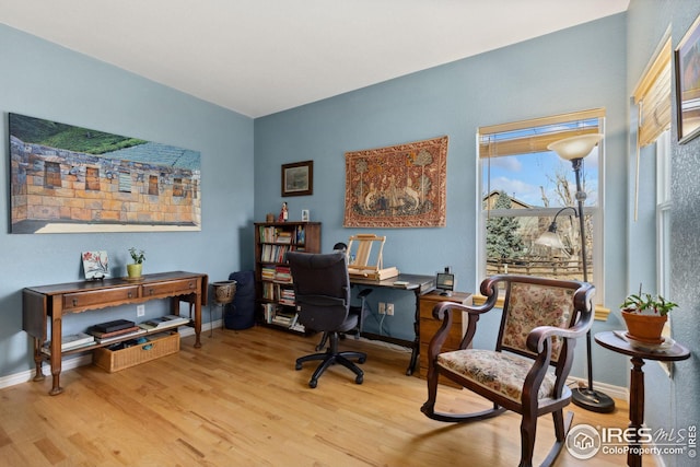 office space featuring baseboards and light wood-style floors