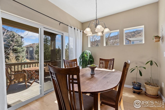 107 Bohn Ct, Lyons, CO 80540 - dining room with light wood-style flooring, a chandelier, plenty of natural light, and baseboards