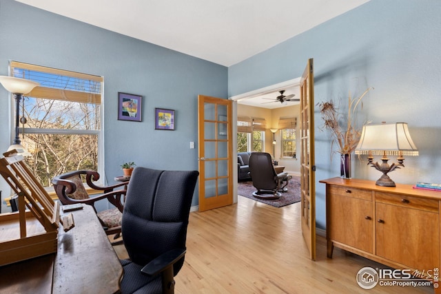 office space featuring french doors, baseboards, and light wood-style flooring