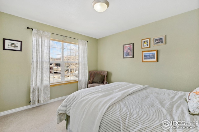 bedroom featuring baseboards and carpet