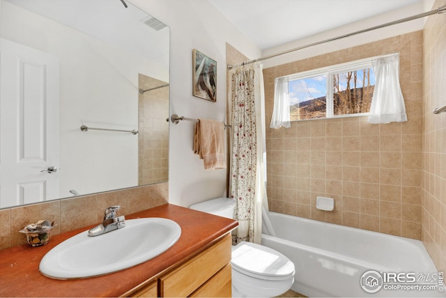 full bath featuring visible vents, toilet, vanity, and shower / bath combo