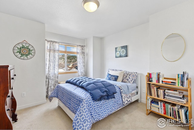 carpeted bedroom featuring baseboards