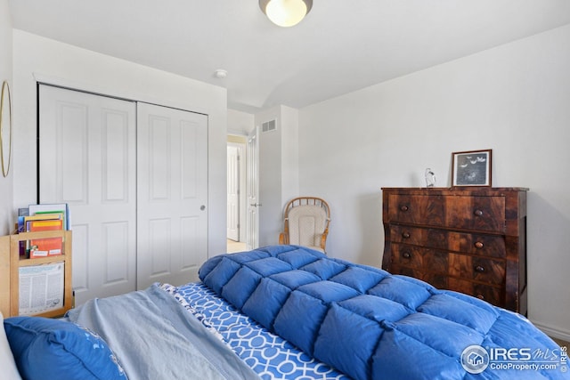 bedroom with a closet and visible vents