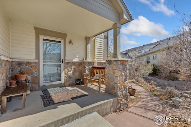 property entrance with stone siding