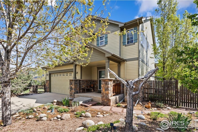 107 Bohn Ct, Lyons, CO 80540 - view of front of property with covered porch, driveway, fence, and stone siding