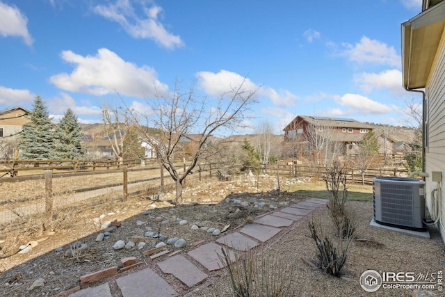 view of yard featuring central AC unit and a fenced backyard