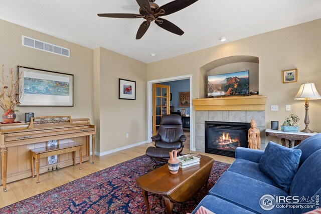 107 Bohn Ct, Lyons, CO 80540 - living room with wood finished floors, a fireplace, a ceiling fan, and baseboards