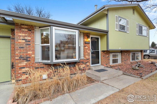 split level home featuring brick siding