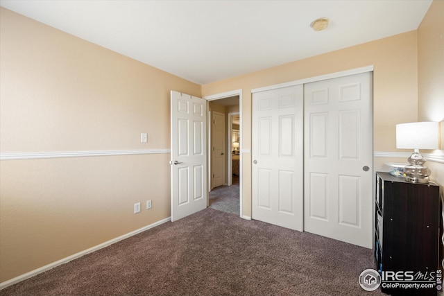 unfurnished bedroom featuring a closet and carpet flooring