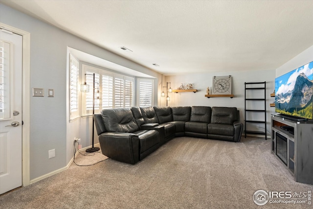 carpeted living area with visible vents and baseboards