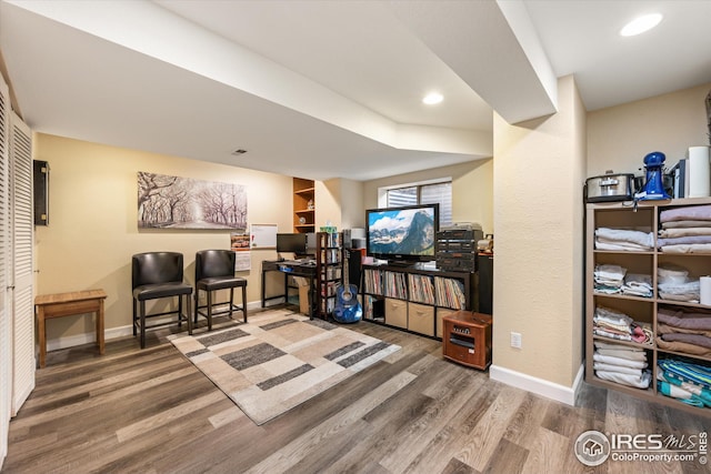 interior space featuring recessed lighting, wood finished floors, and baseboards