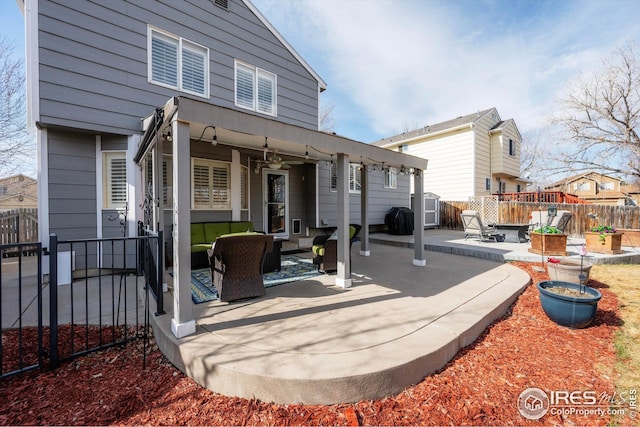 rear view of house with a fenced backyard, an outdoor hangout area, a ceiling fan, and a patio