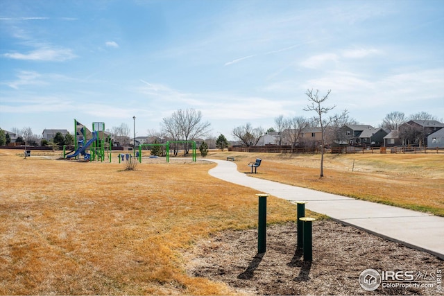 surrounding community with playground community and a lawn