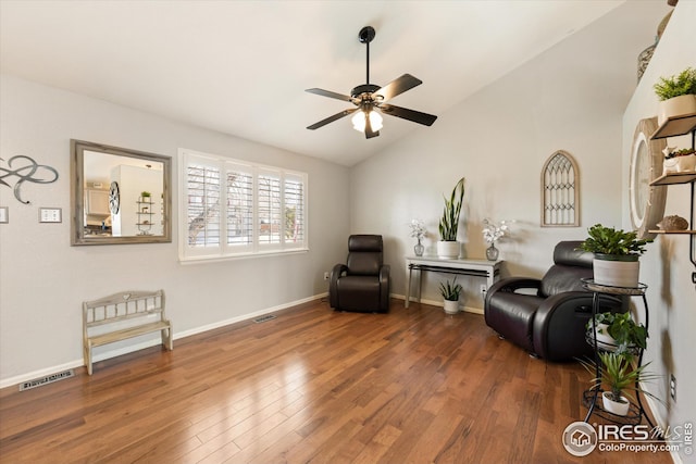 sitting room with visible vents, baseboards, lofted ceiling, wood finished floors, and a ceiling fan