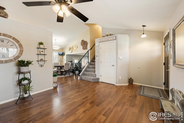 entrance foyer featuring baseboards, ceiling fan, stairway, vaulted ceiling, and wood finished floors