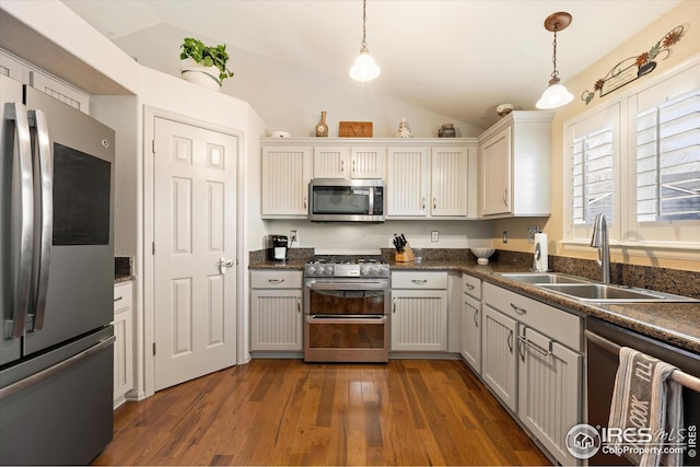 kitchen featuring a sink, dark countertops, and appliances with stainless steel finishes