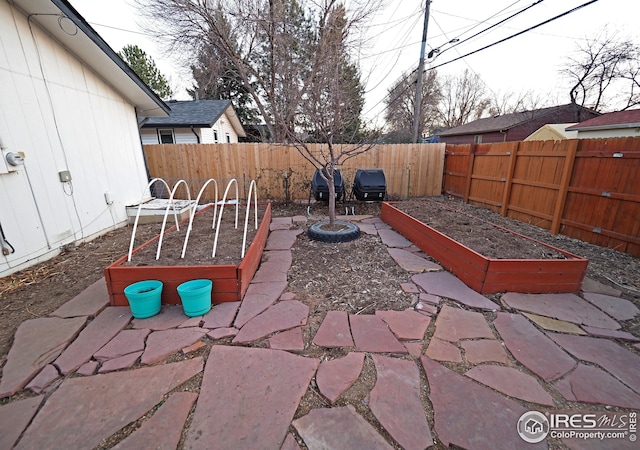 view of patio featuring a fenced backyard and a vegetable garden