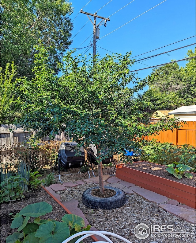 view of patio / terrace featuring a garden and fence