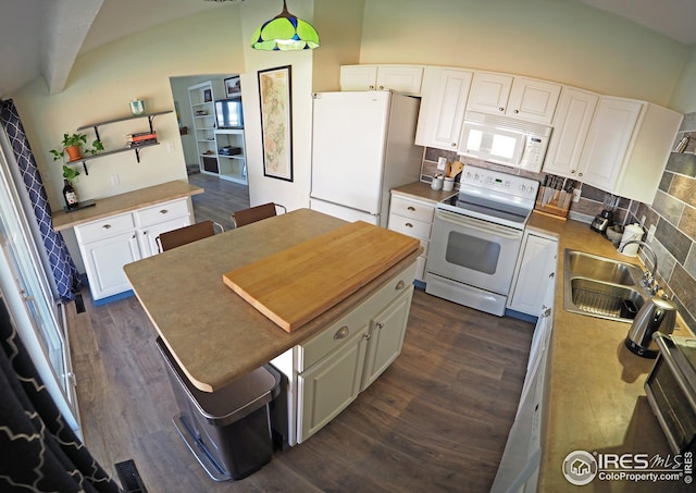 kitchen with backsplash, dark wood-type flooring, white cabinets, white appliances, and a sink