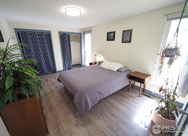 bedroom featuring a textured ceiling and wood finished floors