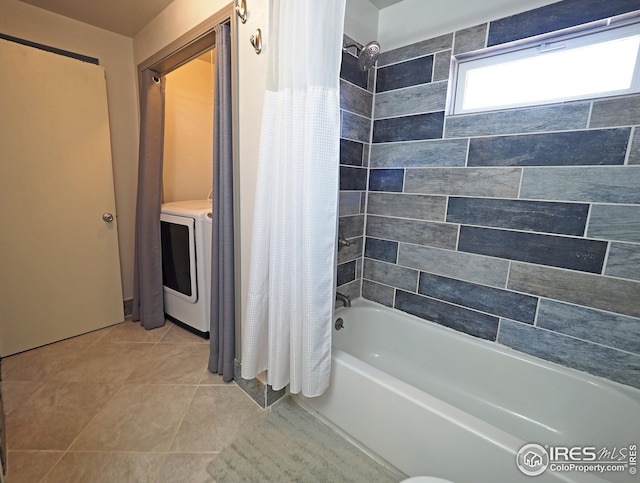 full bath with shower / bathtub combination with curtain, washer / dryer, and tile patterned flooring