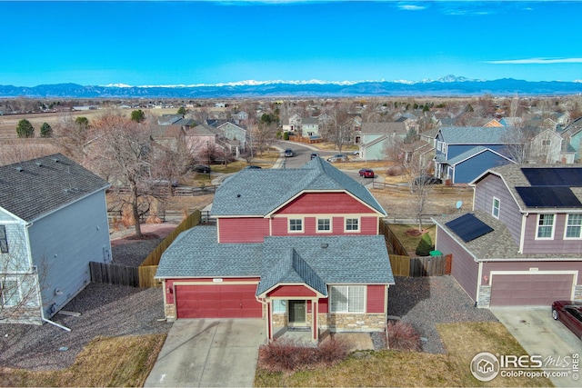 drone / aerial view featuring a residential view and a mountain view