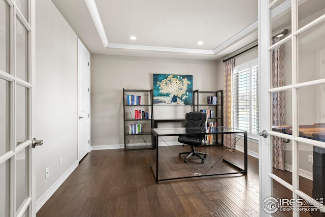 office space with a tray ceiling, wood finished floors, and french doors