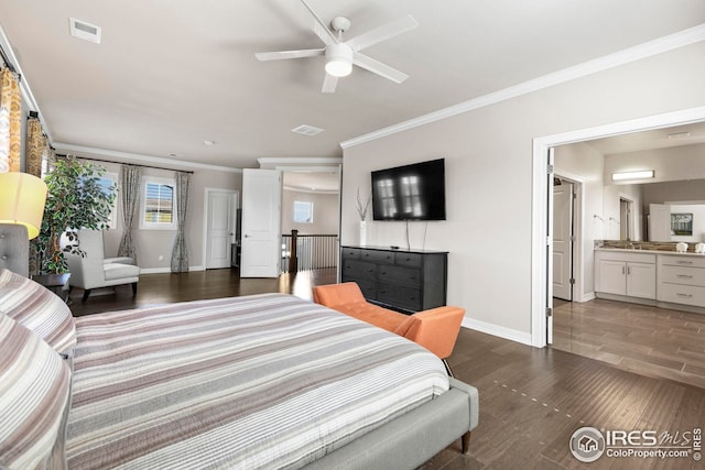 bedroom featuring wood finished floors, visible vents, and baseboards