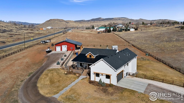 bird's eye view featuring a rural view and a mountain view