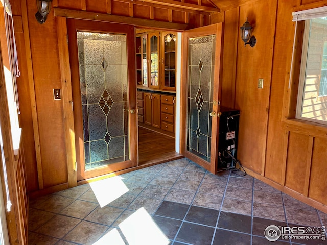 entryway featuring wood walls