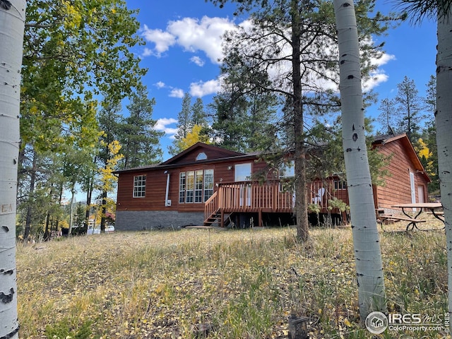 back of property featuring a wooden deck