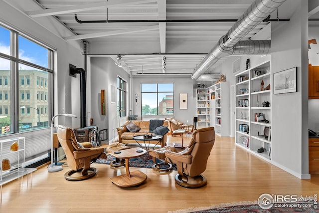 living area featuring built in features and wood finished floors