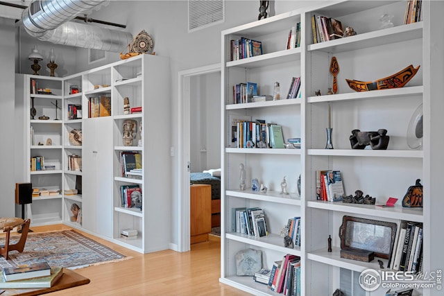 sitting room featuring visible vents and wood finished floors