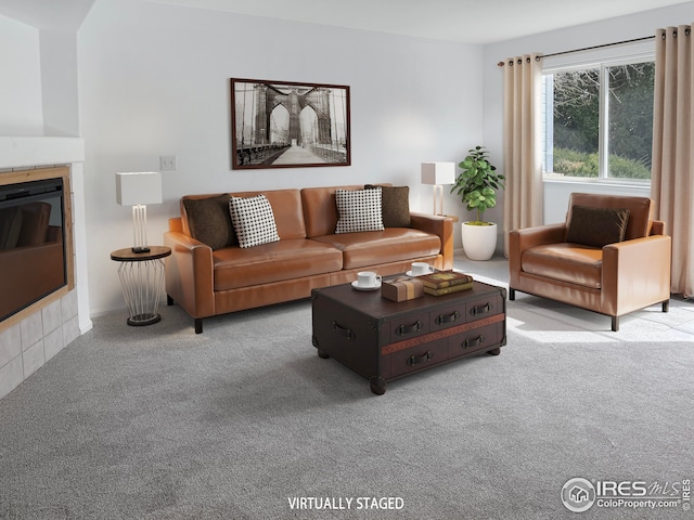 carpeted living area with a tiled fireplace